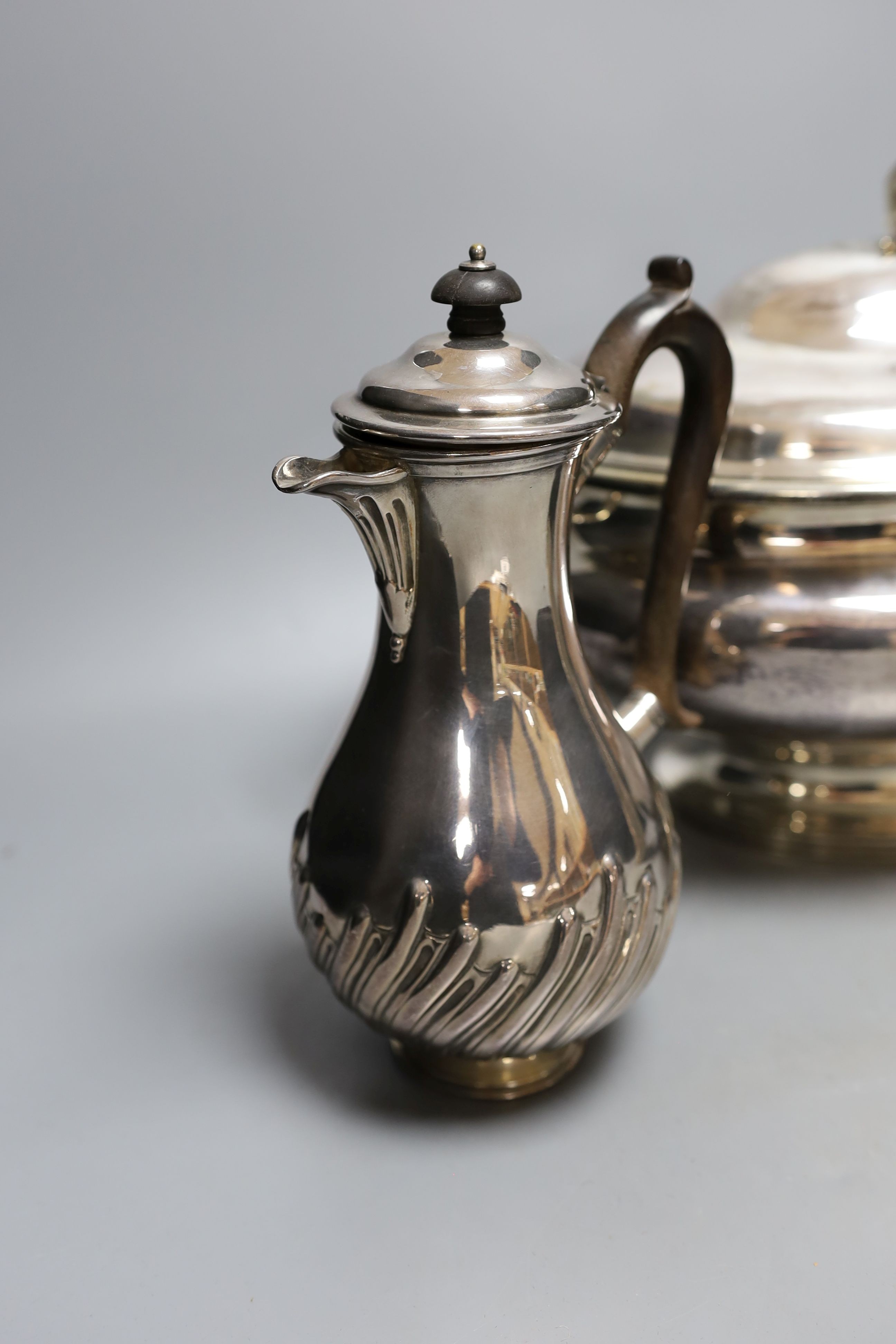 A plated oval two handled soup tureen and cover and a plated coffee pot, tureen, 39 cms wide.